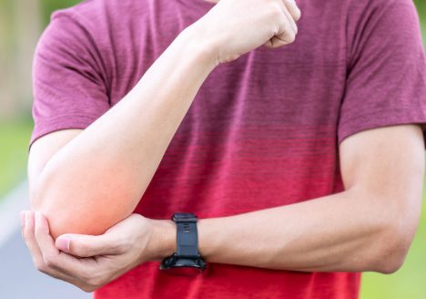 Man feeling discomfort in elbow